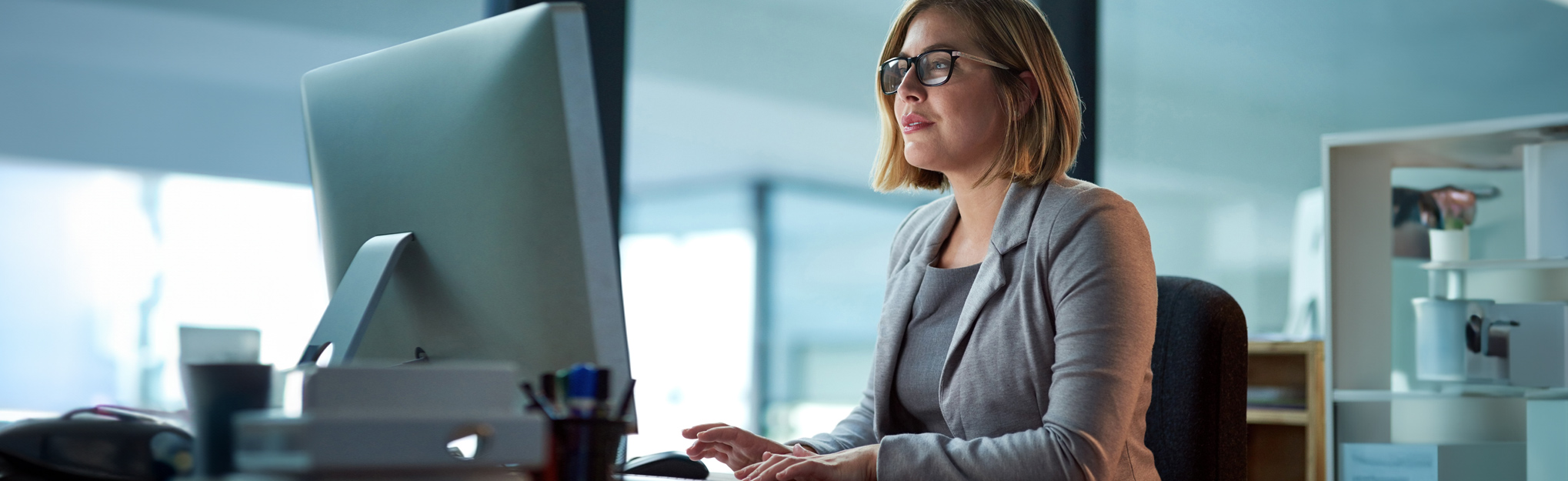 woman using her computer at desk