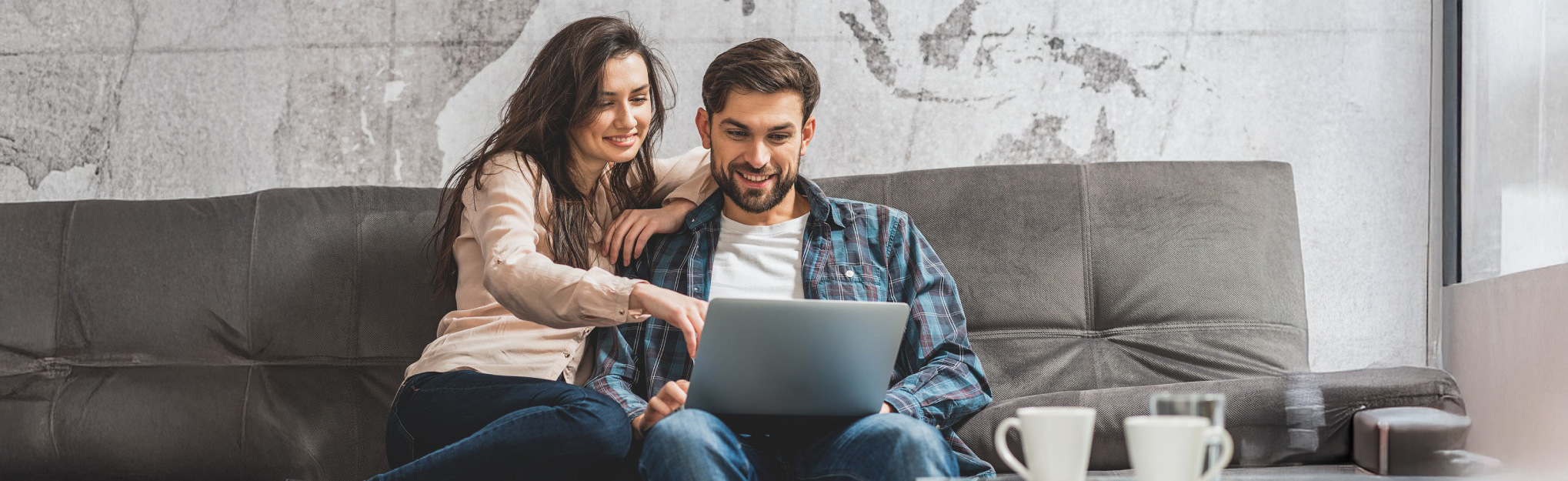 a couple using computer on the couch