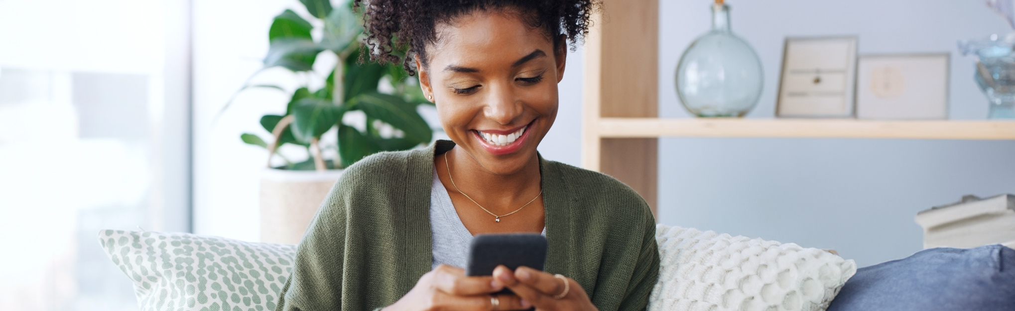 a couple using their mobile banking app to deposit a check 